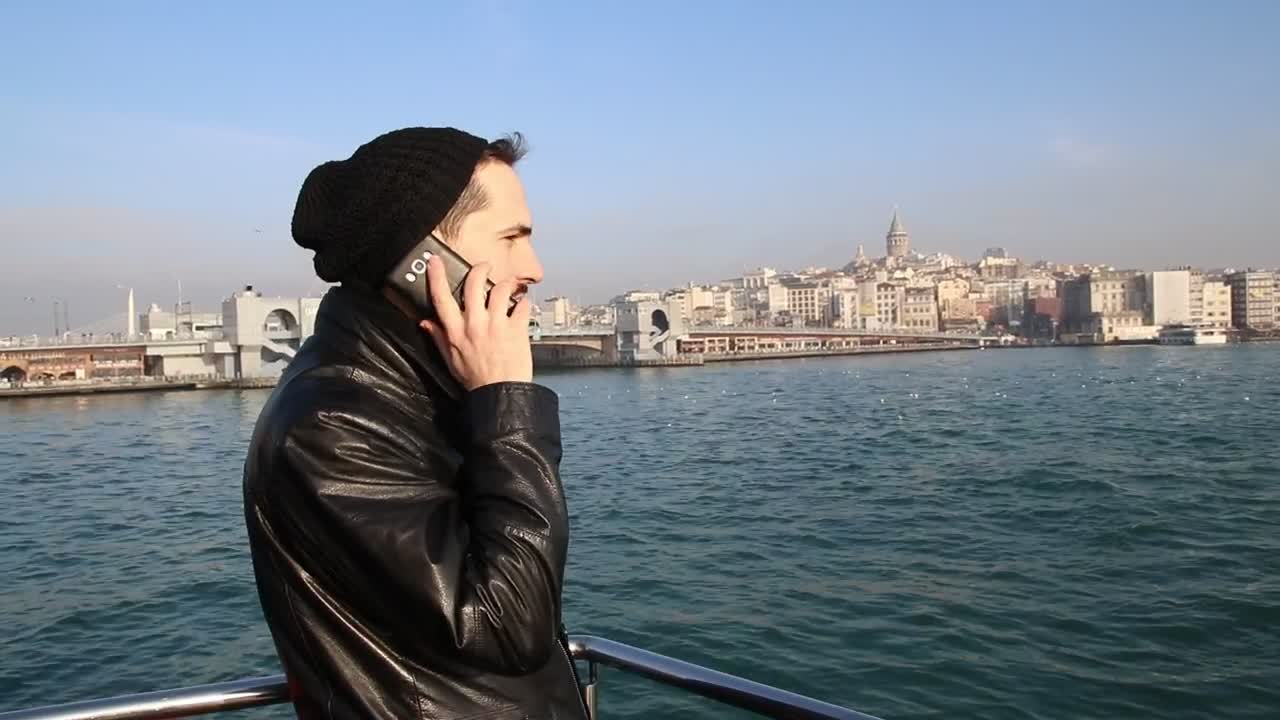 Download Stock Video Man In A Call Standing On A Boat Animated Wallpaper