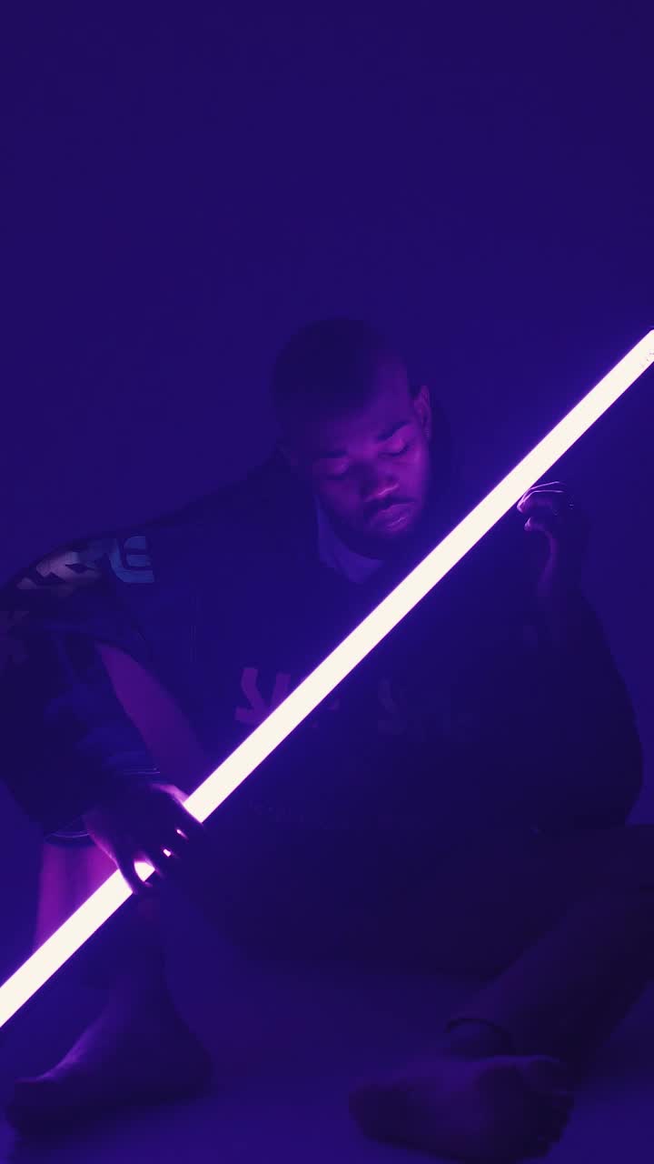 Download Stock Video Man Holding Neon Light Animated Wallpaper