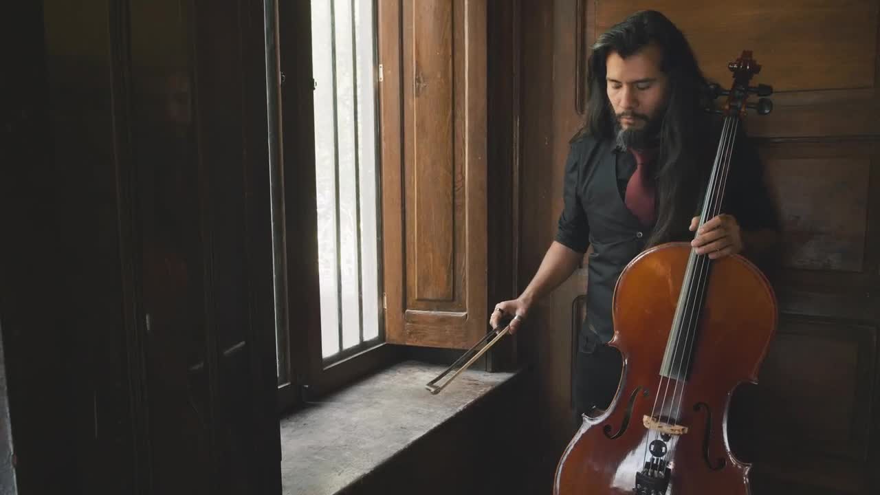 Stock Video Man Holding A Cello Animated Wallpaper