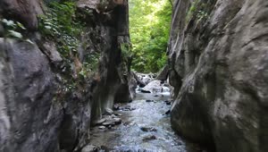 Stock Video Man Hiking In A Stream Between Rocks Animated Wallpaper