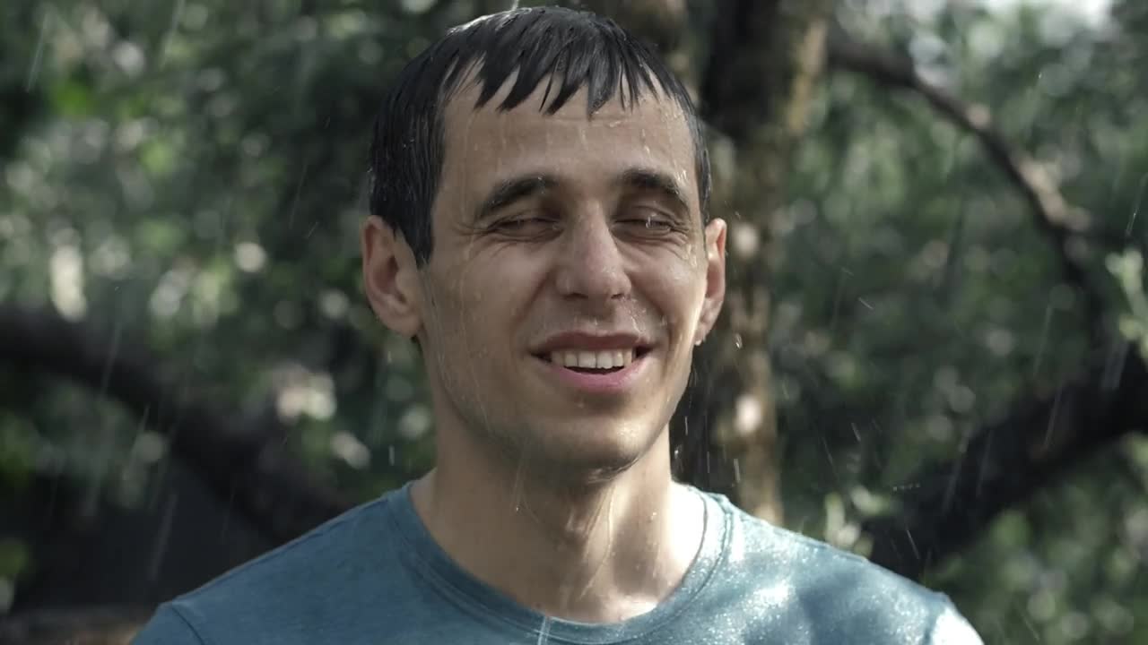 Download Stock Video Man Happily Getting Wet In The Rain Animated Wallpaper