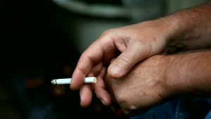 Stock Video Man Hand Holding A Lit Cigarette Animated Wallpaper