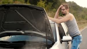Stock Video Man Frustrated With His Broken Down Car On A Road Animated Wallpaper