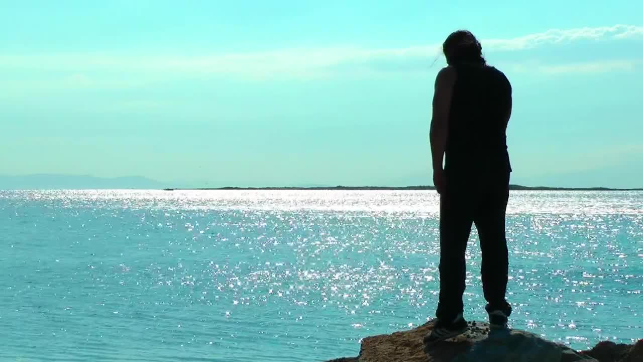 Download Stock Video Man Exercising On A Cliff By The Sea Animated Wallpaper