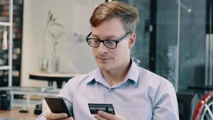 Stock Video Man Entering His Credit Card Details On A Cell Phone Animated Wallpaper