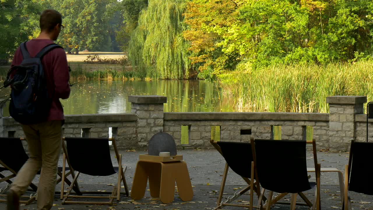 Download Stock Video Man Drinking Tea On The Shore Of A Lake Animated Wallpaper