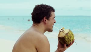 Stock Video Man Drinking From A Coconut Animated Wallpaper