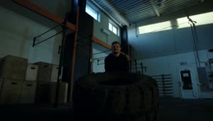 Stock Video Man Doing Crossfit Exercises With A Big Tire Animated Wallpaper