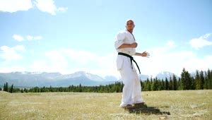 Stock Video Man Demonstrates Karate Kick In Outdoor Landscape Animated Wallpaper