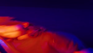 Stock Video Man Dancing With An Orange Light Bar Animated Wallpaper