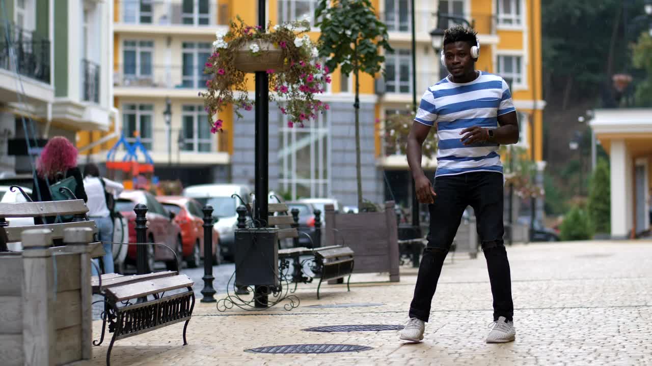 Download Stock Video Man Dancing In The Street With Headphones Animated Wallpaper