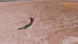 Stock Video Man Crossing The Desert On His Motorcycle Animated Wallpaper
