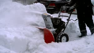 Stock Video Man Clearing Snow With A Snow Blowing Machine Animated Wallpaper