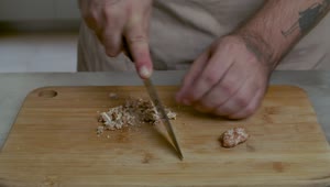 Stock Video Man Chopping Walnuts On A Wooden Board Animated Wallpaper