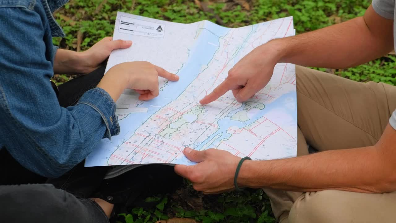 Download Stock Video Man And Woman In Nature Analyzing A Map Together Animated Wallpaper