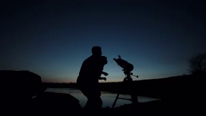 Stock Video Man And A Boy You Using The Telescope At Dusk Animated Wallpaper