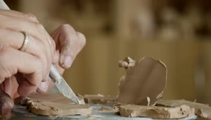 Stock Video Male Hands Working On Clay With Cutting Tools Animated Wallpaper