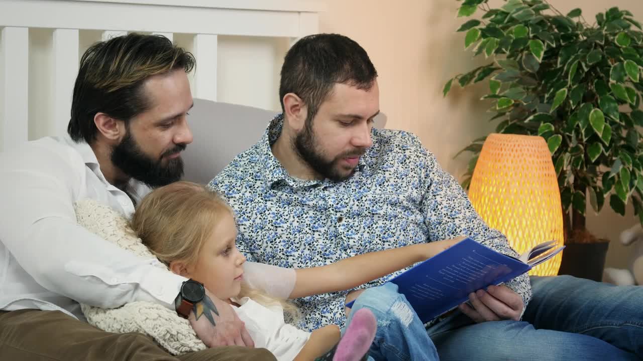 Download Stock Video Male Couple Reading A Story To A Child Animated Wallpaper