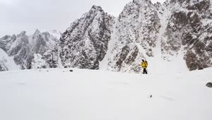 Stock Video Male Climber Walking Through The Snow In The Mountains Animated Wallpaper