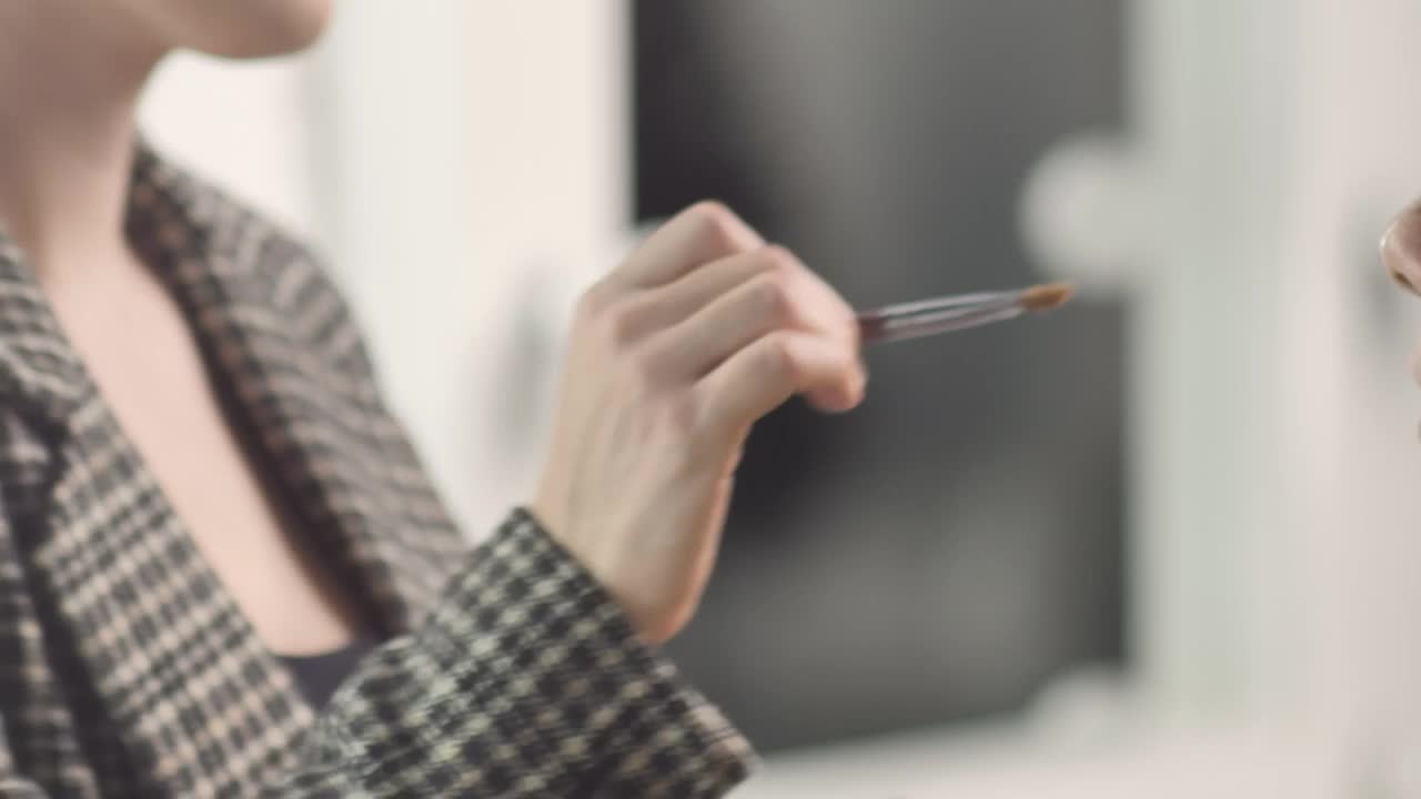 Download Stock Video Making Up A Young Female Model Animated Wallpaper