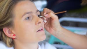 Stock Video Makeup Artist Applying Eye Makeup To A Woman Animated Wallpaper