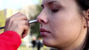 Stock Video Make Up Artist Applying Makeup Outdoors Animated Wallpaper
