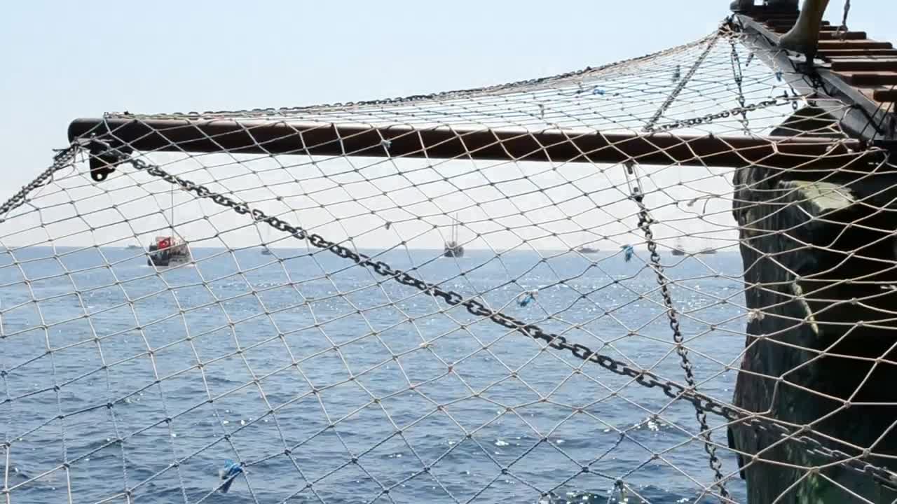 Download Stock Video Looking Through Boat Nets At The Coast Animated Wallpaper