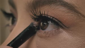 Stock Video Look Of A Girl While Putting Makeup On Her Eyelids Animated Wallpaper