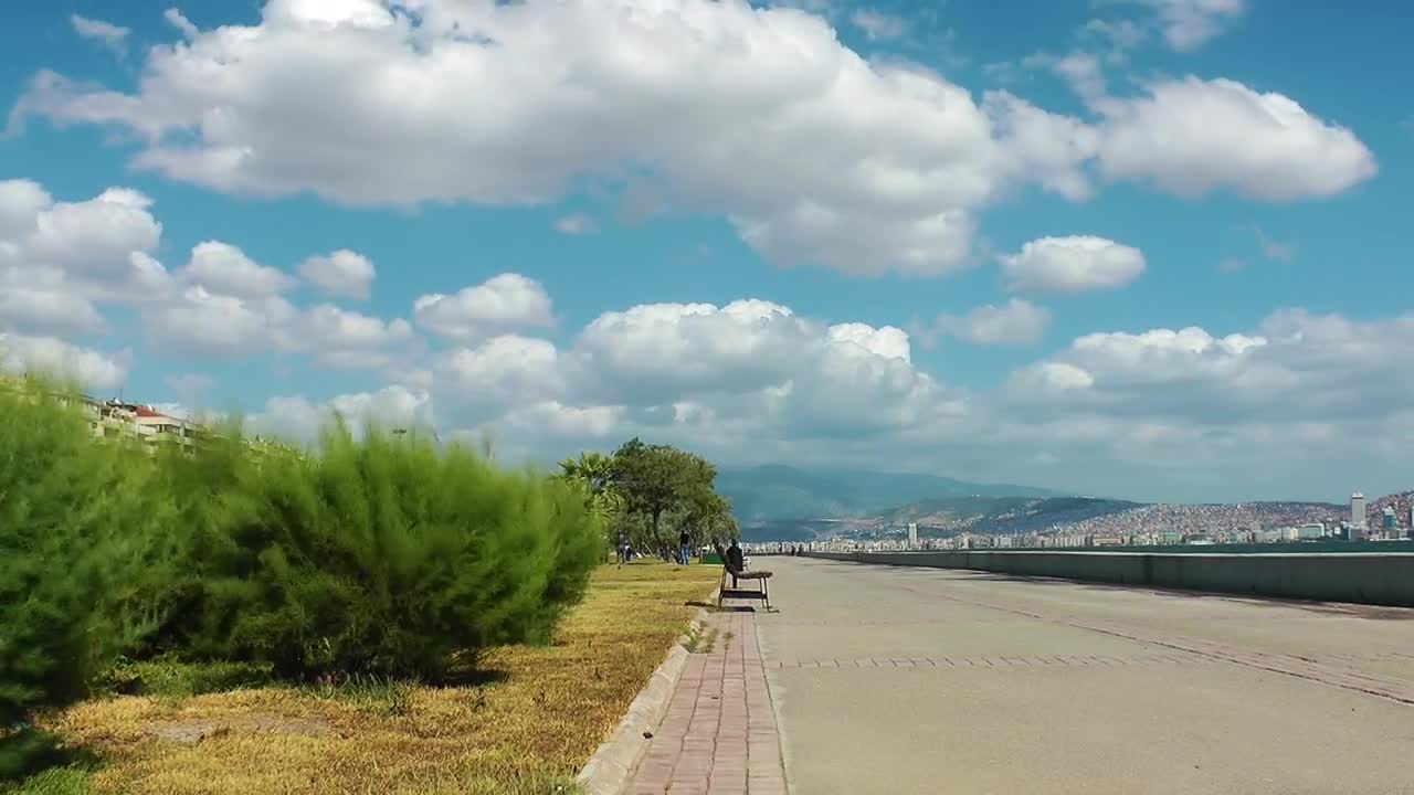 Download Stock Video Long Walker Beside The Sea On A Sunny Day Animated Wallpaper