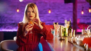 Stock Video Lonely Girl Sipping Her Drink In A Bar Animated Wallpaper