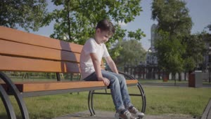Stock Video Lonely Boy On A Park Bench Animated Wallpaper