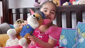Stock Video Little Smiling Girl With A Stuffed Toy Animated Wallpaper