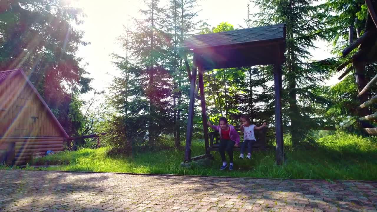 Download Stock Video Little Girls On A Swing In The Country House Animated Wallpaper