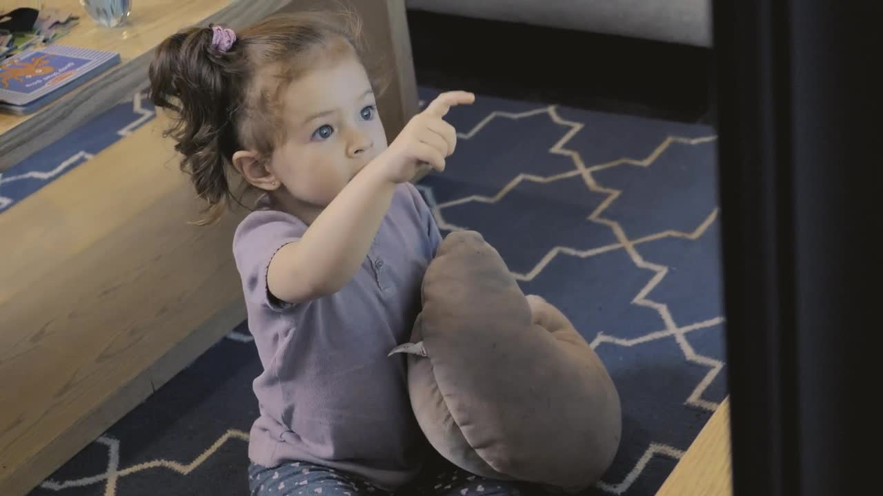 Download Stock Video Little Girl Watching Tv Animated Wallpaper
