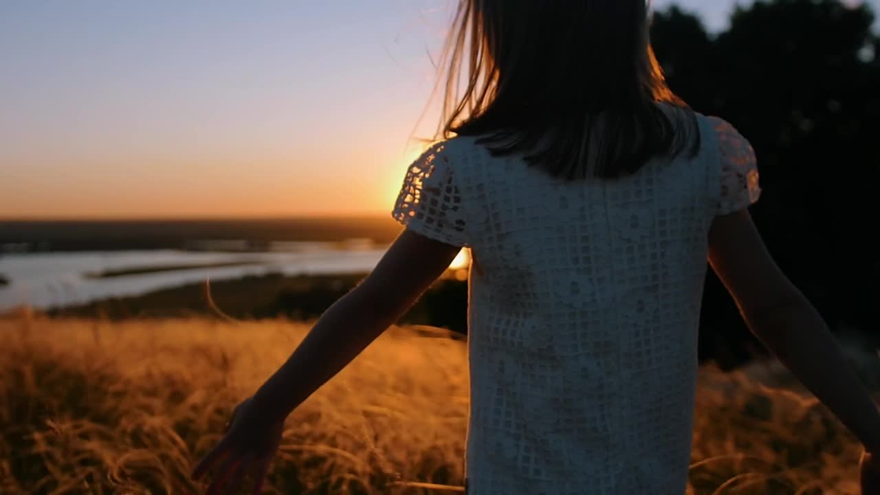Download Stock Video Little Girl Walking In The Valley At Sunset Animated Wallpaper