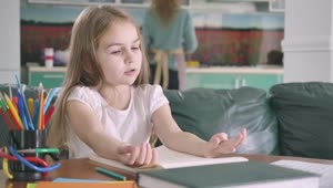 Stock Video Little Girl Studying Mathematics In Her Living Room Animated Wallpaper