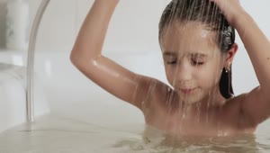 Stock Video Little Girl Rinsing Out The Shampoo From Her Hair In Animated Wallpaper
