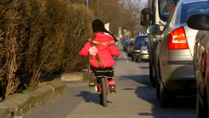 Stock Video Little Girl Riding A Bike Through The Streets Animated Wallpaper