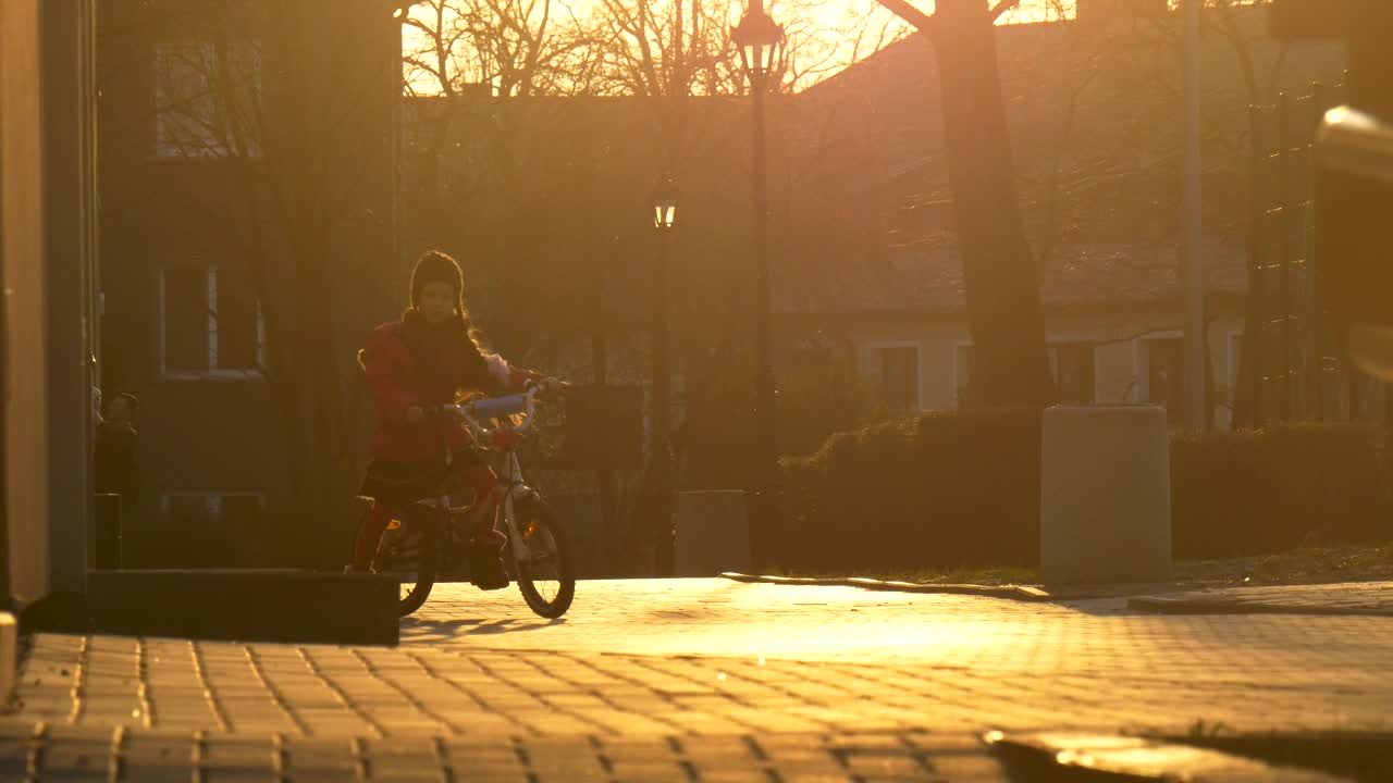 Download Stock Video Little Girl Riding A Bike In The Sunset Animated Wallpaper