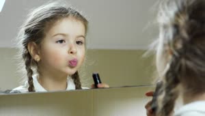 Stock Video Little Girl Puts On Lipstick In The Mirror Animated Wallpaper