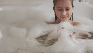 Stock Video Little Girl Plays With Foam In The Bathtub Animated Wallpaper