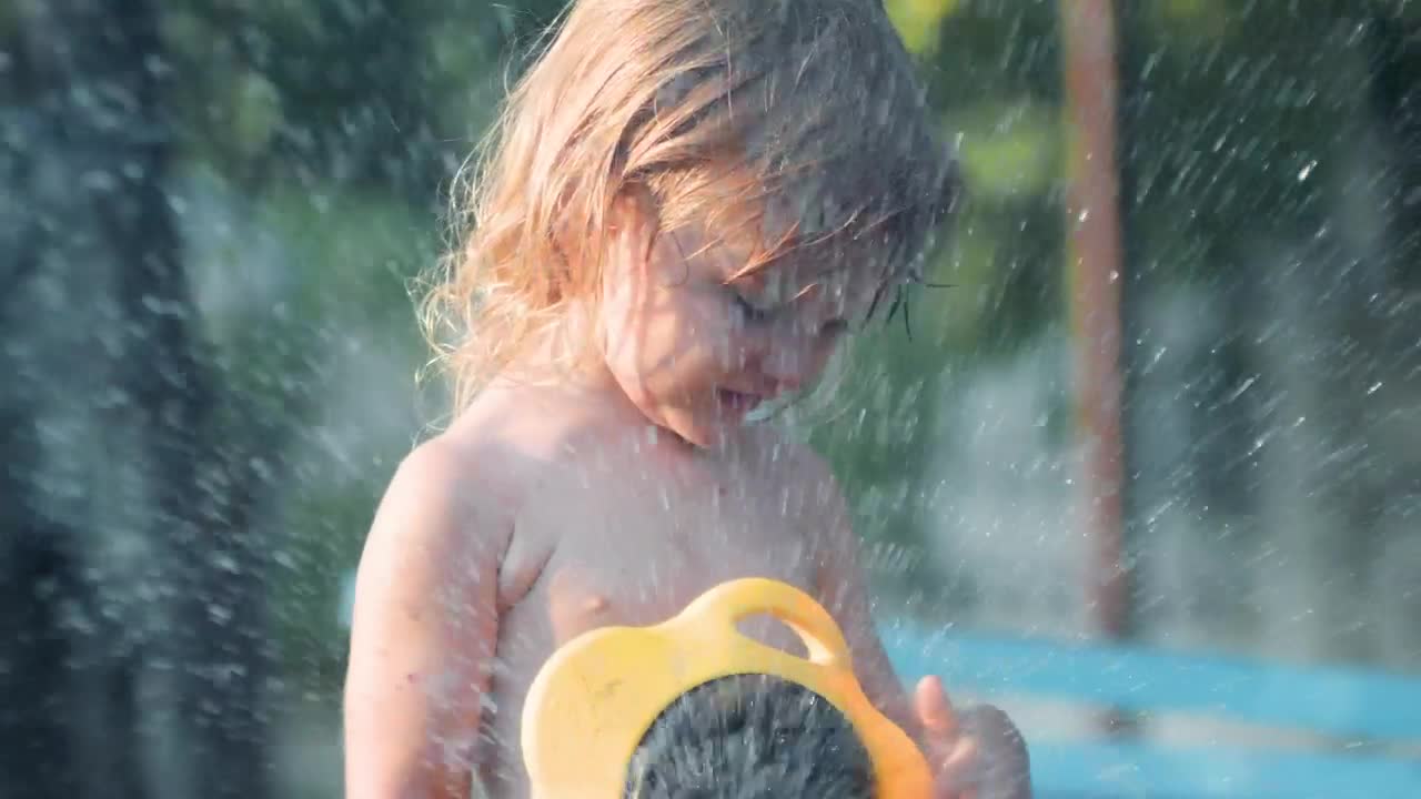 Download Stock Video Little Girl Playing With Water In The Garden Animated Wallpaper