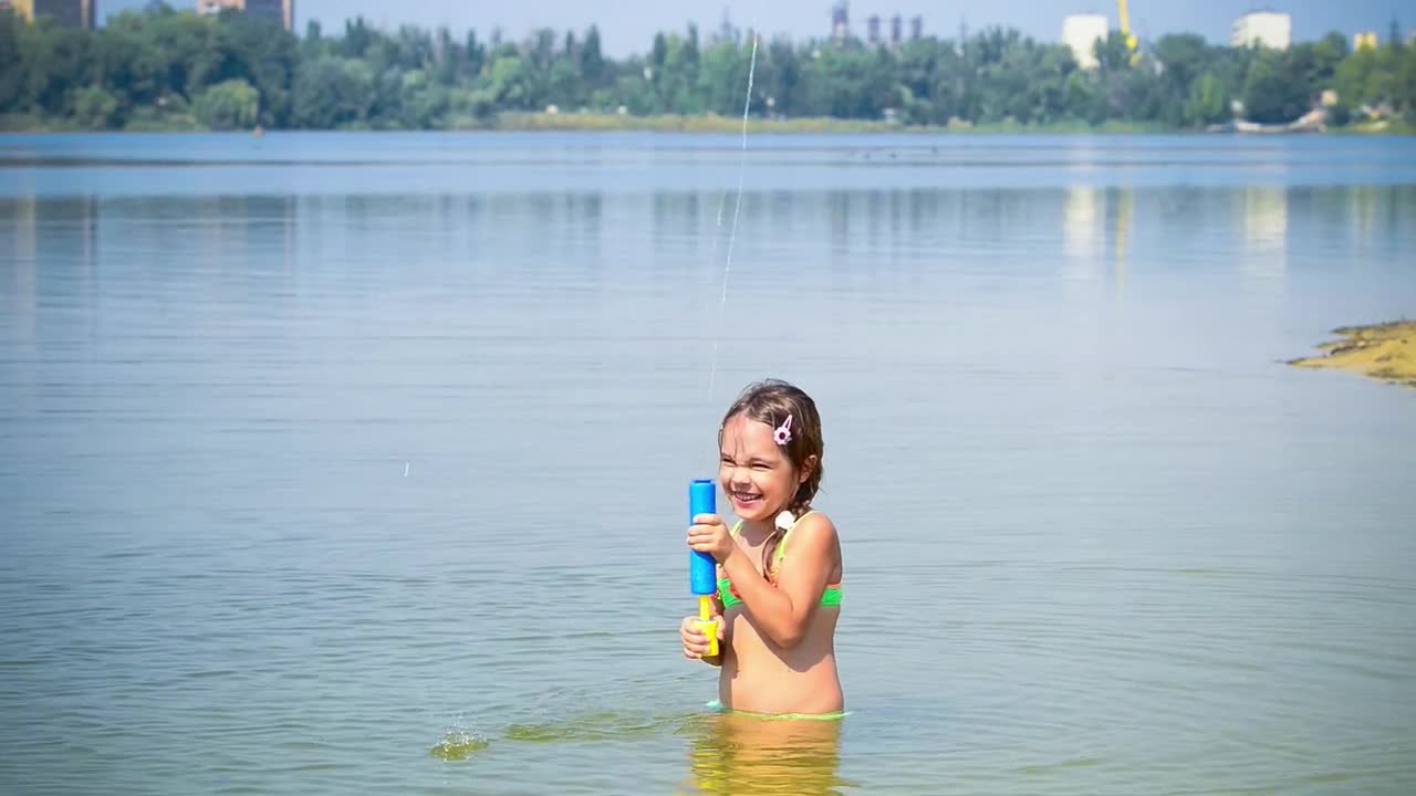 Download Stock Video Little Girl Playing With Toy In A Lake Animated Wallpaper