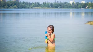 Stock Video Little Girl Playing With Toy In A Lake Animated Wallpaper