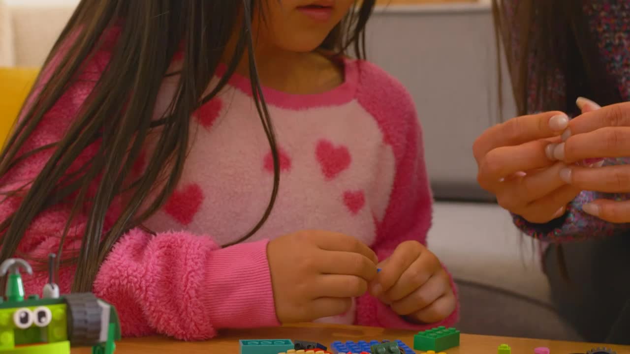 Download Stock Video Little Girl Playing With Legos With Mom Animated Wallpaper