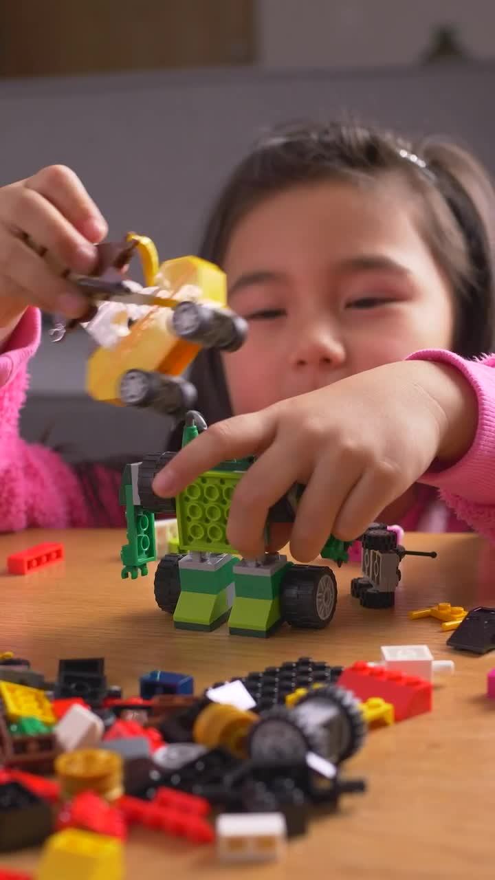 Download Stock Video Little Girl Playing With Her Legos Animated Wallpaper