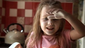 Stock Video Little Girl Playing With Flour On The Kitchen Animated Wallpaper