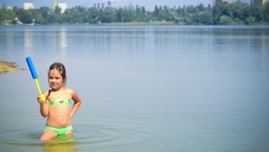 Stock Video Little Girl Playing In A Lake Animated Wallpaper