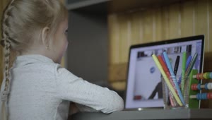 Stock Video Little Girl Paying Attention To Online Class Animated Wallpaper
