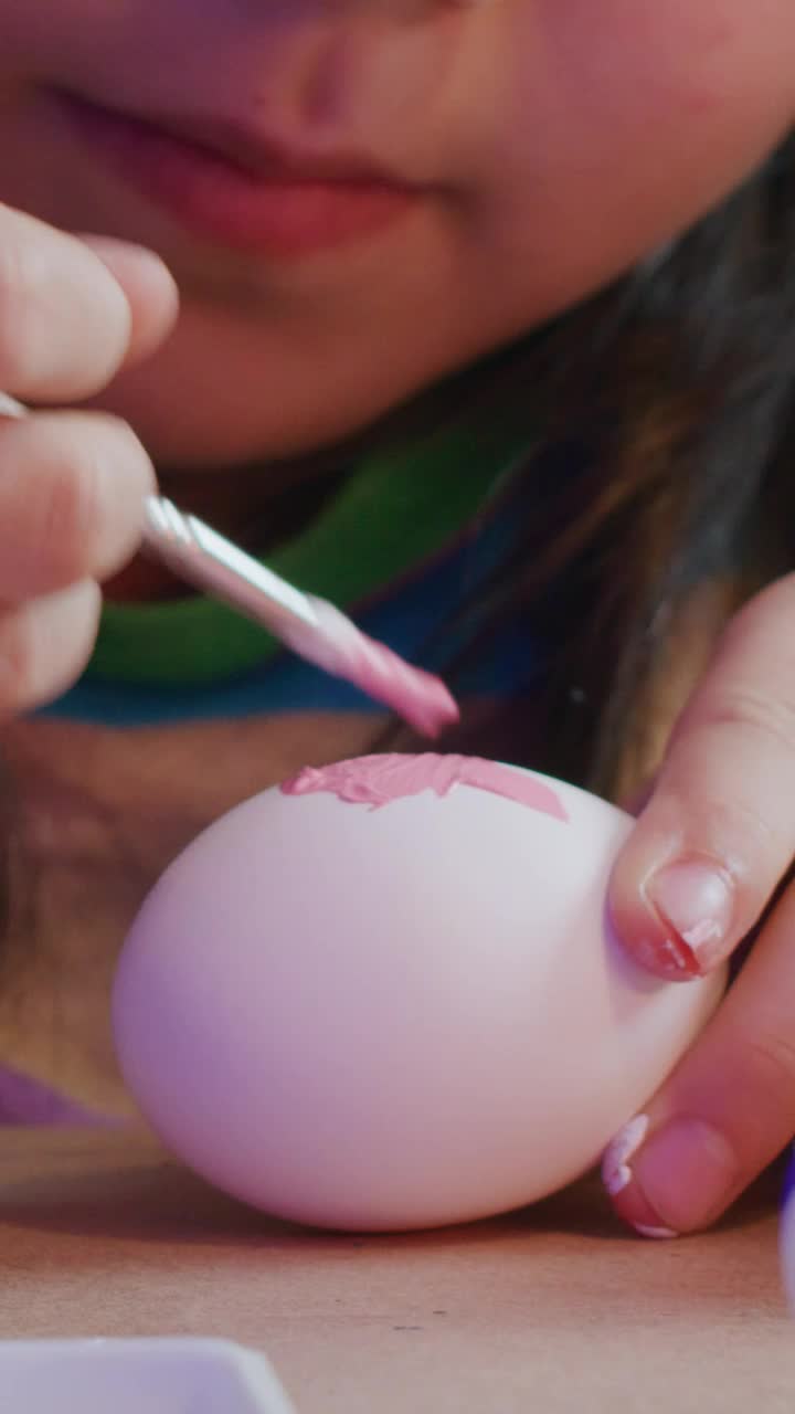 Download Stock Video Little Girl Paints Easter Eggs Close Up Animated Wallpaper